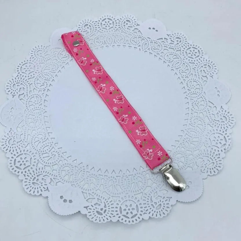 Porta chupetes rosados mariposas